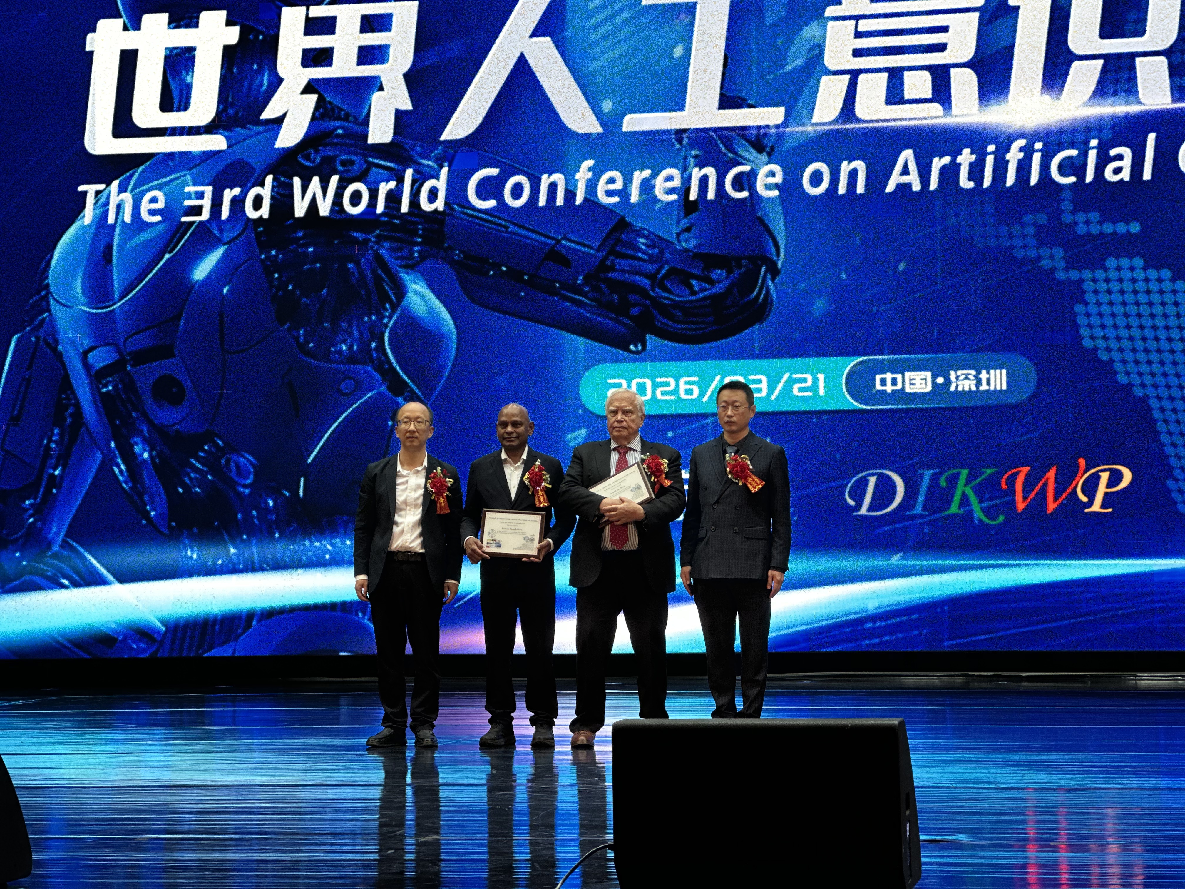 Professor Yucong Duan presenting a certificate